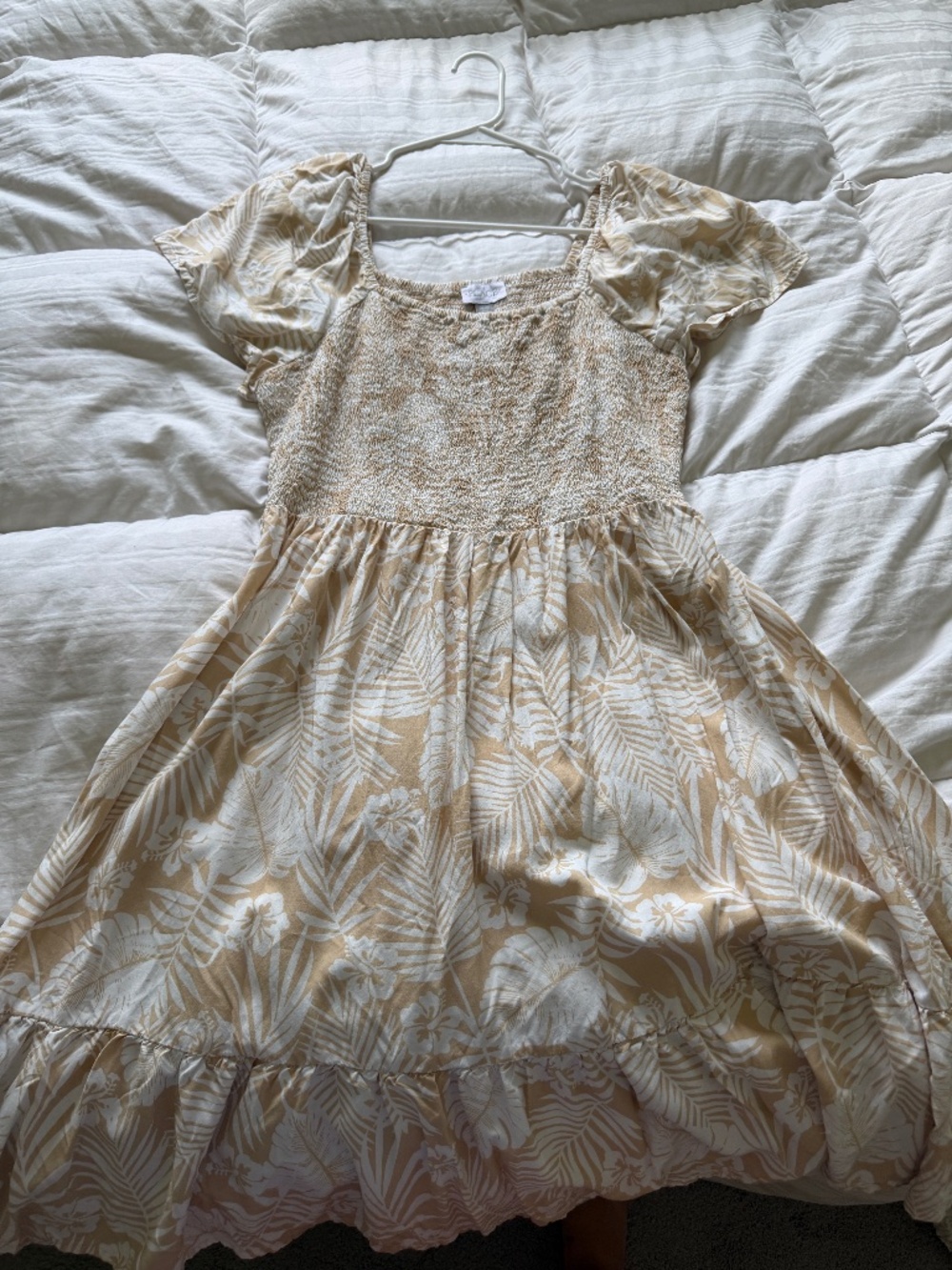 White flower and tan dress